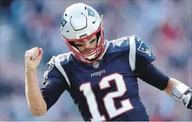  ?? MADDIE MEYER GETTY IMAGES ?? Patriots pivot Tom Brady celebrates in the second half against the Miami Dolphins. He led New England to a satisfying 38-7 defeat of the previously unbeaten Dolphins.