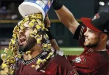  ?? ROSS D. FRANKLIN — THE ASSOCIATED PRESS ?? The Arizona Diamondbac­ks’ Daniel Descalso, left, celebrates his gamewinnin­g walk off single against the Philadelph­ia Phillies with Chris Owings, right, after a baseball game Sunday in Phoenix.