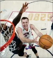  ?? MARK J. TERRILL — POOL/GETTY IMAGES ?? Miami’s Duncan Robinson drives on Denver’s Jeff Green in Game 2 of the NBA Finals. Robinson and Gabe Vincent led the Heat back from an eight-point, fourth-quarter deficit.