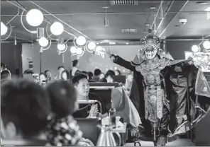  ?? BLOOMBERG ?? An artist performs face-changing tricks at a Haidilao hotpot restaurant in Hong Kong on Saturday.