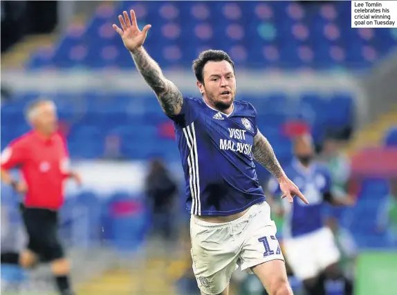 ??  ?? Lee Tomlin celebrates his cricial winning goal on Tuesday