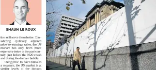  ?? /Reuters ?? Easing: A man walks past the Bank of Japan building in Tokyo. Central banks such as the Bank of Japan continue to run quantitati­veeasing programmes, while the US recently cut its corporate tax rate.