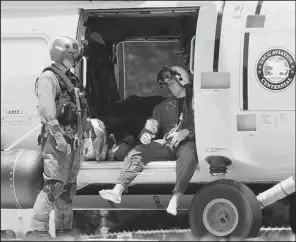  ?? AP/ The Virginian- Pilot/ L. TODD SPENCER ?? A Navy aviator involved in a crash Thursday of two Navy jets waits to get off a Coast Guard helicopter that took him to a hospital in Norfolk, Va.