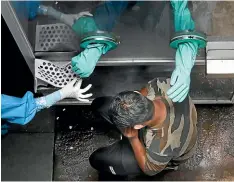  ?? AP ?? A health worker takes a nasal swab of a person for Covid19 test at a hospital in New Delhi.