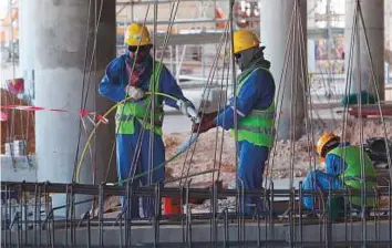  ?? AFP ?? Migrant labourers work on a constructi­on site on October 3, 2015 in Doha. Qatar, the 2022 World Cup host, is under fire over claims of using forced labour.