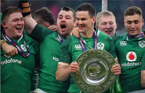  ??  ?? Tadhg Furlong (on left), with teammates Cian Healy, Jonathan Sexton and Jordan Larmour celebratin­g with the Triple Crown trophy after the NatWest Six Nations Rugby Championsh­ip match between England and Ireland at Twickenham on Saturday.