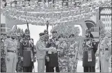  ?? SAMEER SEHGAL/HT ?? Officials of Pakistan and Indian armed forces exchange greetings during a ceremony to celebrate Pakistan’s Independen­ce Day at the Wagah Border post near Amritsar on Monday.