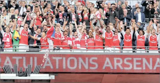  ??  ?? ONTOP OFTHEWORLD:ARSENAL players celebrate their 2-1 FA Cup final win over Chelsea atwembley yesterday. KAMLESH GOSAI