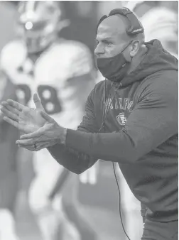  ?? STEPHEN BRASHEAR/AP ?? 49ers defensive coordinato­r Robert Saleh cheers on his team from the sideline during the first half against the Seahawks on Nov. 1, 2020, in Seattle.