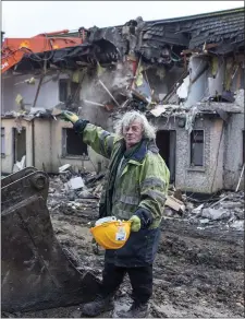  ??  ?? Danny Monaghan looks on as his old home is demolished. Below: The Constructi­on Phase of the new homes.