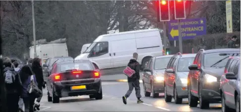  ??  ?? Pupils making their way to Towers School along Faversham Road