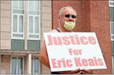  ?? Jeremy stewart ?? Polk County resident Edgar Hood holds a sign in front of Polk County Courthouse No. 1 during a rally Saturday, June 27, to call for justice in the death of Eric Keais.