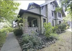  ??  ?? The stone exterior of the 1912 Craftsman-style house in Bellevue.