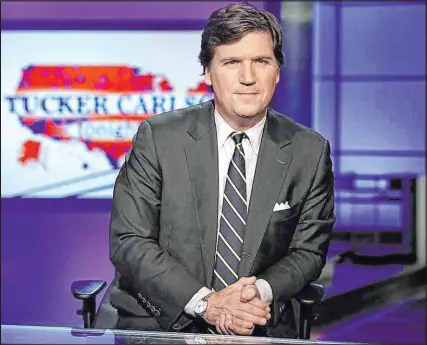  ?? Richard Drew The Associated Press file ?? Tucker Carlson of Fox News looks at the Jan. 6 Capitol insurrecti­on in his new streaming special “Patriot Purge.” Jonah Goldberg calls it “dangerous nonsense.”