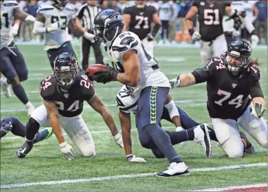  ?? Ap-curtis Compton ?? Seahawks linebacker Bobby Wagner runs after recovering a fumble by Falcons running back Devonta Freeman at the Seahawks one-yard line during the fourth quarter of an NFL football game in Atlanta on Sunday.