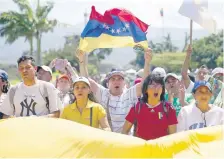  ??  ?? Partidario­s de la oposición venezolana protestaro­n ayer contra el presidente Nicolás Maduro en el puente Simón Bolívar, en Cúcuta, Colombia.