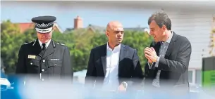  ?? BEN BIRCHALL/THE ASSOCIATED PRESS ?? Britain's Home Secretary Sajid Javid, centre, meets officers in Amesbury, England on Sunday, after a couple was left in critical condition when they were exposed to nerve agent Novichok.