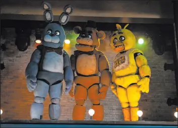  ?? Universal Pictures ?? The animatroni­c Bonnie, from left, Freddy Fazbear and Chica are seen in a scene from “Five Nights at Freddy’s.” The film made $78 million in the North American box office.