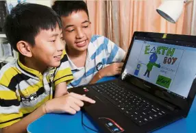  ??  ?? Emerson (left) and Sheldon created an online game – Earth Boy Recycling
Game – to help kids learn about the 3rs (reduce, reuse and recycle).