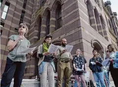  ?? Jim Michaud/Hearst Connecticu­t Media ?? Ellen Rubin, left, a Jewish Voices for Peace member, speaks during a Passover Seder ceremony where Jews spoke out against Israel's war in Gaza on April 2, in front of New Haven City Hall.