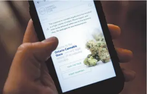  ?? CITIZEN NEWS SERVICE PHOTO ?? The Ontario Cannabis Store website is pictured on a mobile phone Ottawa on Thursday.