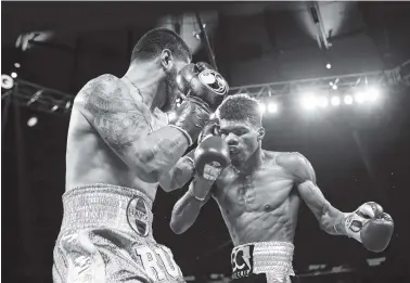  ?? THE ASSOCIATED PRESS ?? Ryan Martin, right, looks to throw a punch against Bryant Cruz during the seventh round of a lightweigh­t continenta­l championsh­ip match last March in New York. Martin stopped Cruz in the eighth round.