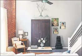  ??  ?? A vintage wardrobe from the 1800s serves as a focal point and adds storage in this Florence, Alabama, living room featured in Kim Leggett's book “City Farmhouse Style.” [ALISSA SAYLOR PHOTOS]