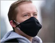  ?? SARAH L. VOISIN — THE WASHINGTON POST ?? Danny Ryan, 27, is pictured wearing two masks on Wednesday near his home in Washington, D.C. Double masks are becoming a real possibilit­y as a new virus variant makes its way from England, South Africa, and Brazil into the U.S.