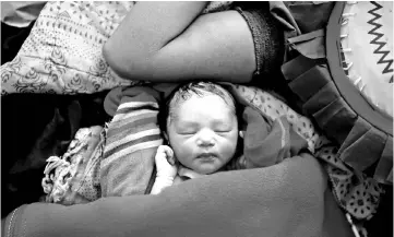  ??  ?? A newborn baby is pictured next to her mother Zahida Begum, 22, a Rohingya refugee after the delivery at a medical centre in Kutupalong refugee camp near Cox’s Bazar, Bangladesh. — Reuters photo