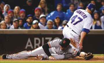  ?? Associated Press photos ?? San Francisco Giants third baseman Christian Arroyo can’t make a catch on a throw as Chicago Cubs’ Miguel Montero looks on during the seventh inning of Wednesday’s game at Wrigley Field in Chicago. Montero scored on the play, and the Cubs won 5-4.