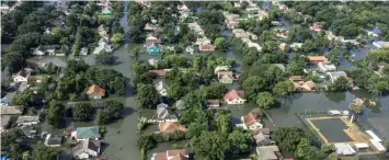  ??  ?? HARVEY’S WAKE Slow-moving Hurricane Harvey, which made landfall near Houston in August 2017 (outskirts of the city shown), dumped record amounts of rain across southeaste­rn Texas. Researcher­s say Harvey’s extreme rainfall is likely linked to climate change.