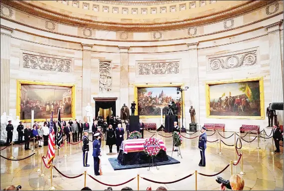  ??  ?? US President Donald Trump and First Lady Melania Trump pay their respects as former US President George H. W. Bush lies in state in the Rotunda of the US Capitol in Washington, DC on Dec 3. The body of the late former president travelled from Houston to Washington, where he will lie in state at the US Capitol through Wednesday morning. Bush, who died on Nov 30, will return to Houstonfor his funeral on Thursday.