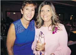  ??  ?? Gala chair Sue Paish congratula­ted Women of Distinctio­n recipient, Mary-Jo Dionne, an award-winning writer, editor and producer.