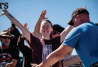  ?? — AFP photos by Sergio Flores and Michael Gonzalez ?? Felecia Hicks is baptized at the Take Back Our Border Convoy rally at Cornerston­e Children’s Ranch near Quemado, Texas.