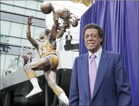  ?? AP file photo ?? Elgin Baylor stands next to a statue honoring him outside Staples Center on April 6, 2018. Baylor, the Lakers’ 11-time NBA All-Star, died Monday. He was 86.