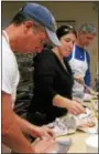  ?? TONY PHYRILLAS — DIGITAL FIRST MEDIA ?? Volunteers man the Gyro sandwich assembly line at the annual Greek Food Bazaar at Sts. Constantin­e & Helen Greek Orthodox Church. The popular event features all kinds of Greek dishes made by parishione­rs.