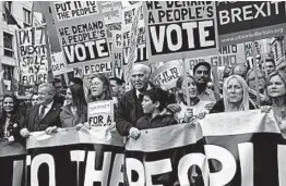  ?? DAN KITWOOD/GETTY ?? Liberal Democrat leader Sir Vince Cable, center, joins protesters in London on Saturday calling for a second vote on whether Britain should leave the European Union.