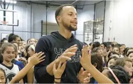  ?? JEFF CHIU/AP ?? The Golden State Warriors’ Stephen Curry greets basketball camp participan­ts at Ultimate Fieldhouse in Walnut Creek, California, in August 2018.