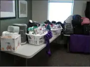  ?? MELISSA SCHUMAN — MEDIA NEWS GROUP ?? Filled backpacks and supplies fill the tables at Unity House, ready for donation to statewide domestic violence shelters.
