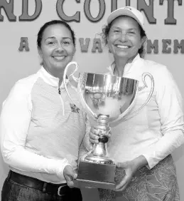  ?? CONTRIBUTE­D PHOTOS ?? President of the Jamaica Golf Associatio­n Jodi Munn Barrow (left) presents the National Amateur Golf Championsh­ip trophy to Michelle McCreath.