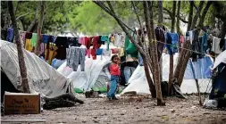  ?? Bob Owen / Staff file photo ?? A girl plays outside her family’s tents at the camp for asylumseek­ers in Matamoros, Mexico, last November. The camp once held more than 2,500 migrants; now it has less than 1,000.