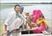  ?? HT PHOTO ?? Villagers travel by boat in Keria village in the Thar desert after the Narmada dam released excess water.