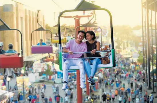  ?? INDIANA STATE FAIR ?? A couple enjoys a bird’s-eye view of the Indianapol­is fairground­s from the Skyride.