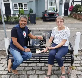  ??  ?? Brian Langston returned the medals to Teresa Bruce at the memorial in the village green.