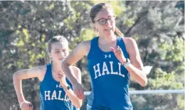  ?? SHAWNMCFAR­LAND/ HARTFORD COURANT ?? Hall runners Nora Holmes and Kate Sanderson placed second and third in a dual-meet against rival Conard. Conard’s Chloe Scrimgeour took first.