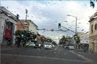  ?? RECORDER PHOTO BY CHIEKO HARA ?? Rain drops cover a vehicle’s windshield during a rain shower Wednesday, Dec. 5. During the rainy season, authoritie­s warn drivers as well as pedestrian­s to use extra caution while in the streets.