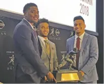  ?? RALPH RUSSO/ASSOCIATED PRESS ?? Heisman Trophy finalists, from left, Dwayne Haskins of Ohio State, Kyler Murray of Oklahoma and Tua Tagovailoa of Alabama pose with the Heisman Trophy on Friday at the New York Stock Exchange in New York.