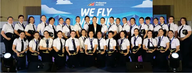  ?? COVER AND INSIDE PHOTOS COURTESY OF PAL ?? Captain Aimee Carandang Gloria — the first Filipina commercial airline pilot and the first female airline captain in Southeast Asia — (standing, center) together with new generation of Philippine Airlines’ women crew members.