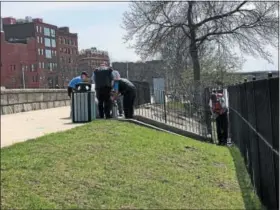  ?? NICHOLAS BUONANNO -- NBUONANNO@TROYRECORD.COM ?? Officials from the Troy Fire Department help an ill elderly man get onto a stretcher after being rescued from his boat in the Hudson River near William D. Chamberlai­n Riverfront Park on Wednesday.