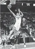  ??  ?? Connecticu­t's Gabby Williams drives past South Carolina's Mikiah Herbert Harrigan during Monday’s game in Albany, N.Y. FRANK FRANKLIN II/AP